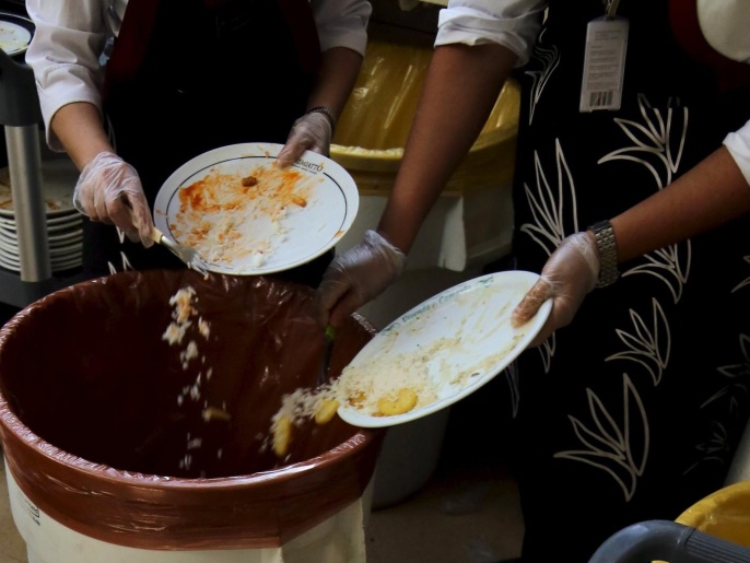 Workers separate food waste at a food court in the Eldorado shopping mall in Sao Paulo, Brazil, July 14, 2015. According to a spokesperson from the mall, the remains of 10,000 meals served each day from its food courts are used as garden compost to produce vegetables on its roof top, which are later harvested and distributed to the mall's employees. The spokesperson added that the mall is able to recycle up to 25% of around 300 tons worth of garbage produced each month. Picture taken July 14, 2015. REUTERS/Paulo Whitaker