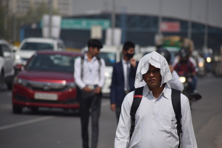 impact of climate change - people trying to save yourself from scorching hot summer now days in India. Gurgaon, India. march 13, 2023.; Shutterstock ID 2274618293; purchase_order: ajanet; job: ; client: ; other: